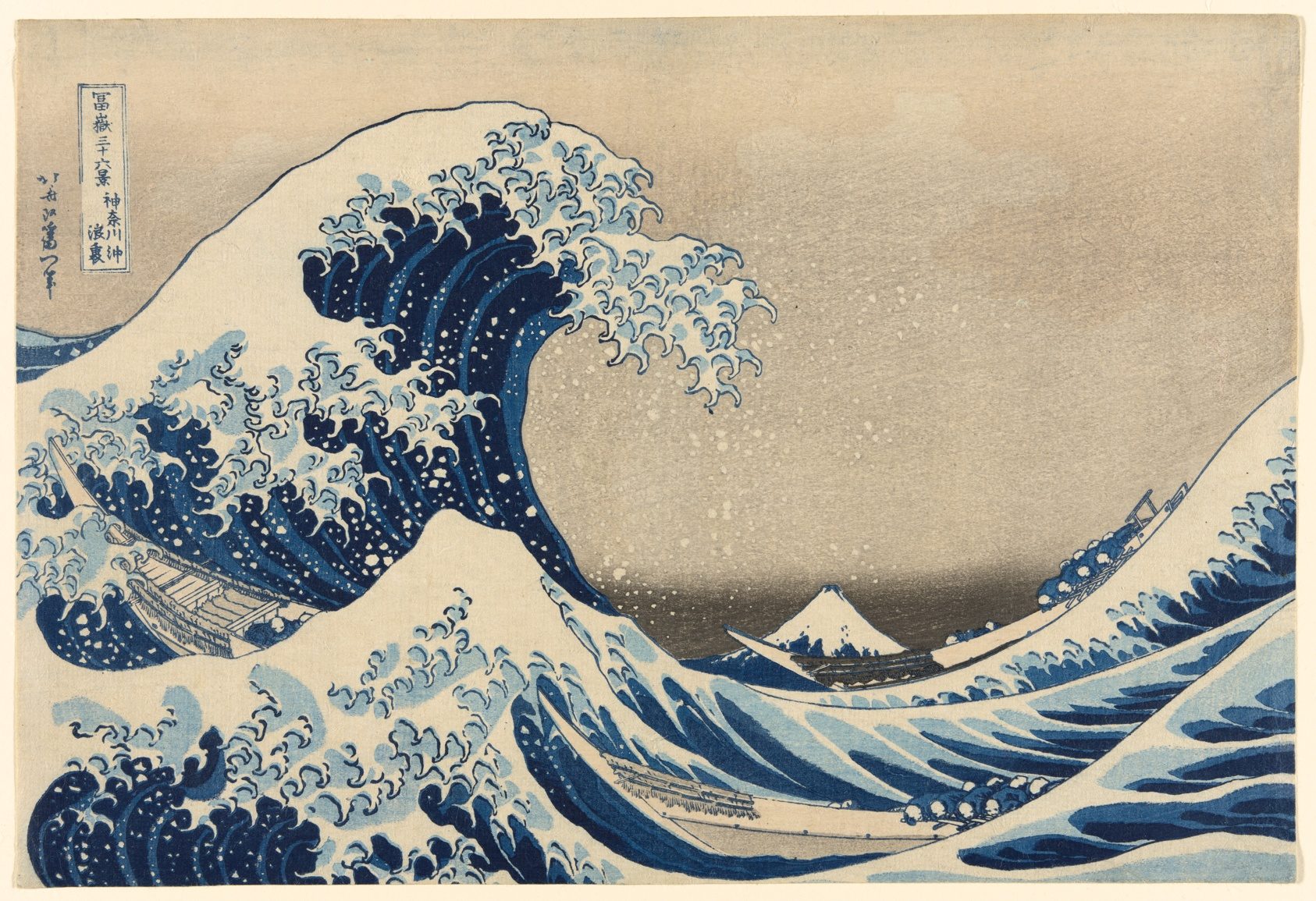 A great wave curling over three boats, with Mount Fuji small in the distance.